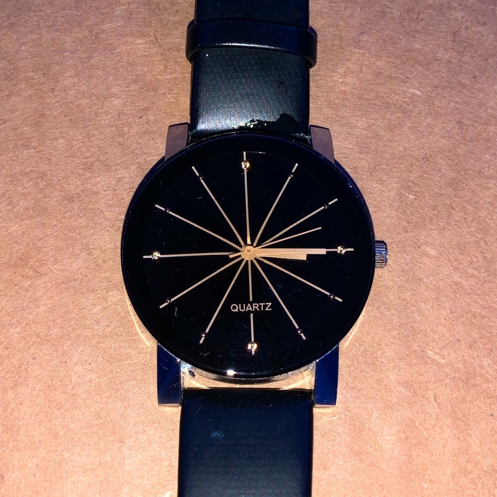 Fashionable black QUARTZ watch with gold dials